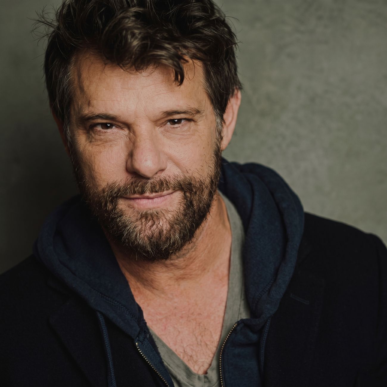 A bearded man in a jacket
