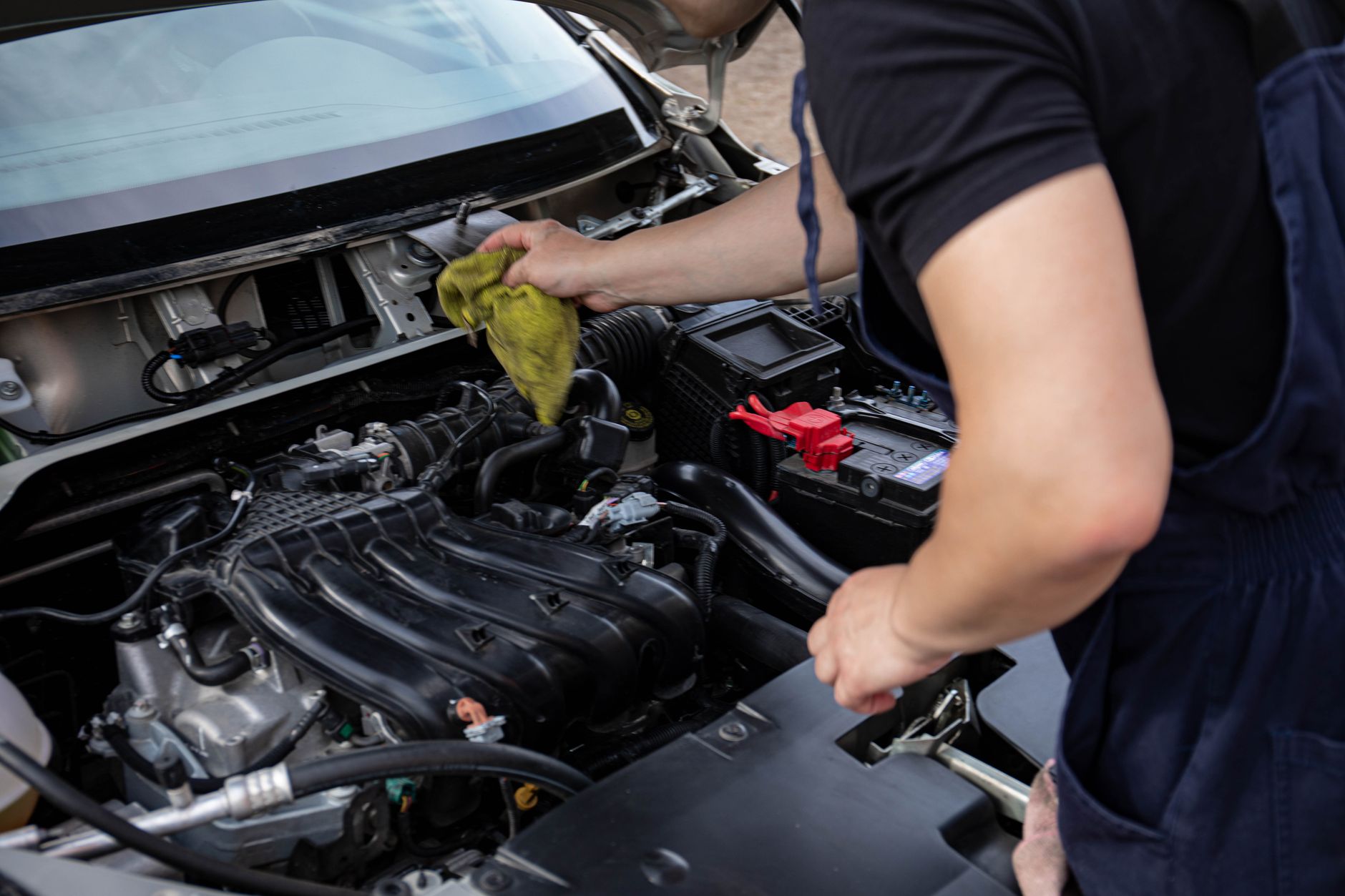 A mechanic repairing a car engine